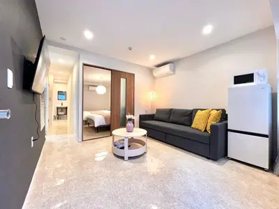 a living room with a couch and a refrigerator at Kojima House 1F-TT0168 in Tokyo