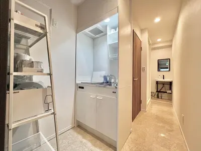 a small kitchen with white cabinets and a ladder at Kojima House 1F-TT0168 in Tokyo