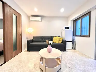a living room with a couch and a table at Kojima House 1F-TT0168 in Tokyo