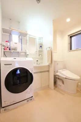 a washing machine in a bathroom with a toilet at Emilio301 in Tokyo
