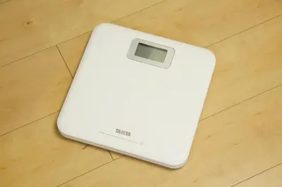 a white electronic device sitting on a wooden floor at Emilio301 in Tokyo