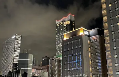 a tall building with lights on top of it in a city at #5 WiFi無料&東新宿4分!歌舞伎町のホテルライク清潔部屋! in Tokyo