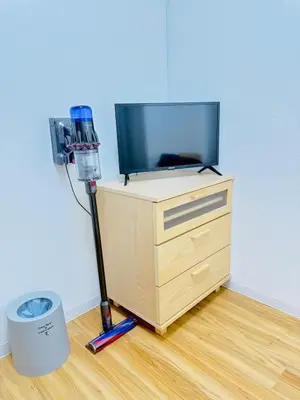 a room with a television and a vacuum at asakusa \u5343\u675f in Tokyo