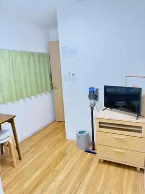 a room with a table and a tv on a dresser at asakusa \u5343\u675f in Tokyo