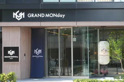 a building with a sign for a grand monday at GRAND MONday GINZA in Tokyo