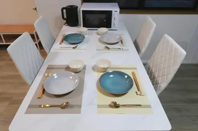 a white table with plates and silverware on it at \u65e5\u548c komagome in Tokyo
