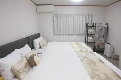 a bedroom with a large bed with white sheets and pillows at \u65e5\u548c komagome in Tokyo