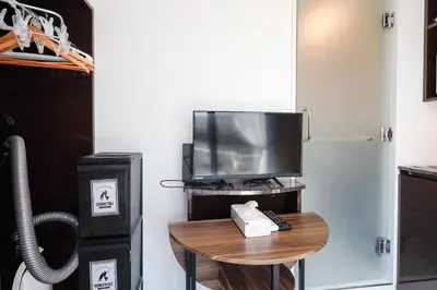 a room with a tv and a table with a television at Ra Grande by Tranova in Tokyo