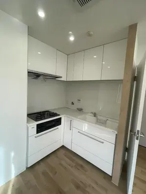 a kitchen with white cabinets and a stove and sink at \u6d45\u8349\u8907\u5f0f\u30a2\u30d1\u30fc\u30c8\u30e1\u30f3\u30c8\u6c11\u5bbf \u6700\u592710\u4eba in Tokyo