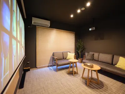 a living room with a couch and two tables at T-home\u96c6 T-home SHU in Tokyo