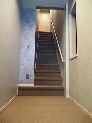 a staircase in a building with blue tile at T-home\u96c6 T-home SHU in Tokyo