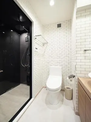 a white bathroom with a toilet and a shower at T-home\u96c6 T-home SHU in Tokyo