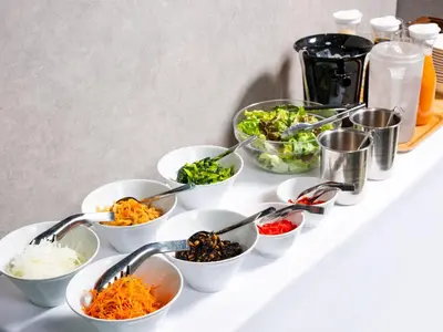 a buffet with bowls of vegetables and spoons at APA Hotel Omori Ekimae Higashi in Tokyo