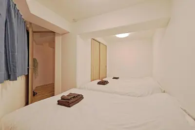 two white beds in a room with a mirror at V Close to Kyodo sta 12 min to Shinjuku in Tokyo