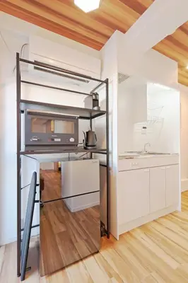 a loft bed in a kitchen with a microwave at V Close to Kyodo sta 12 min to Shinjuku in Tokyo