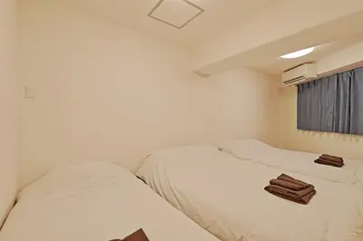 two beds in a room with towels on them at V Close to Kyodo sta 12 min to Shinjuku in Tokyo