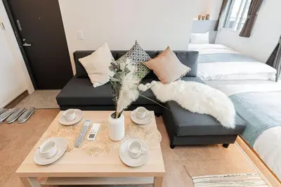 a living room with a couch and a coffee table at SAIEI Hotel in Tokyo