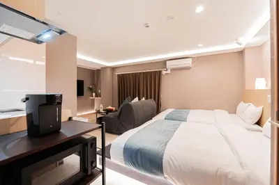 a hotel room with a bed and a television at SAIEI Hotel in Tokyo