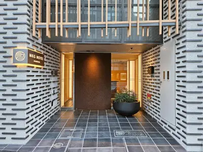 a entrance to a building with a potted plant at MKG HOTEL Asakusa in Tokyo