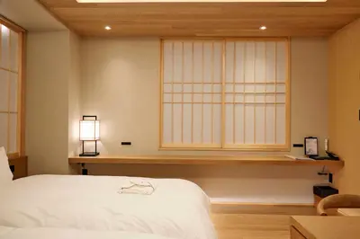 a bedroom with a white bed and a window at MKG HOTEL Asakusa in Tokyo