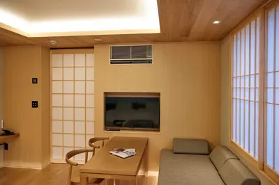 a living room with a couch and a tv at MKG HOTEL Asakusa in Tokyo
