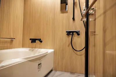 a bathroom with a sink and a bath tub at MKG HOTEL Asakusa in Tokyo