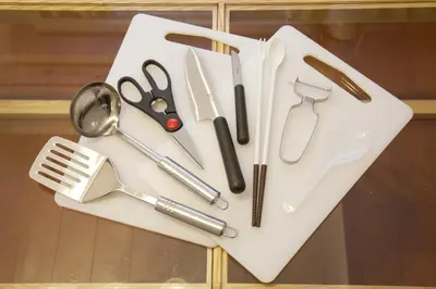 a group of kitchen utensils on a white cutting board at BAi\u6b4c\u821e\u4f0e\u753a2\u4e01\u76ee in Tokyo