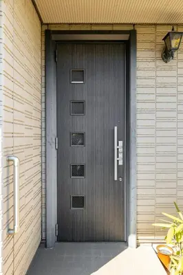 a metal door on a house with at GP House in Tokyo