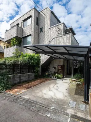 a large building with awning in front of it at GP House in Tokyo