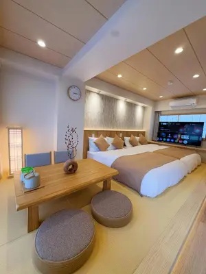 a large bedroom with two beds and a table at SUN House asakusabashi akihabara tokyo in Tokyo