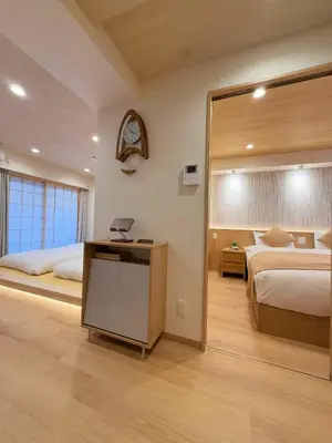 a bedroom with two beds and a mirror at SUN House asakusabashi akihabara tokyo in Tokyo