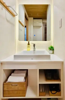 a bathroom with a white sink and a mirror at SUN House asakusabashi akihabara tokyo in Tokyo
