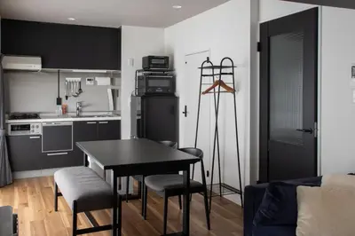 a kitchen with a table and chairs in a room at NIYS apartments 56type in Tokyo