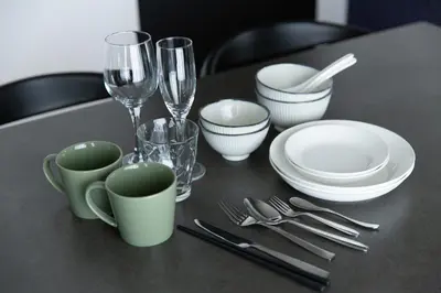 a black table with plates and wine glasses and silverware at NIYS apartments 56type in Tokyo