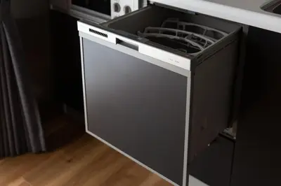 a dishwasher with its door open in a kitchen at NIYS apartments 56type in Tokyo