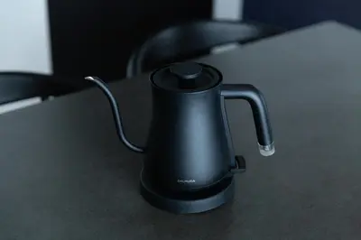 a black kettle sitting on top of a table at NIYS apartments 56type in Tokyo
