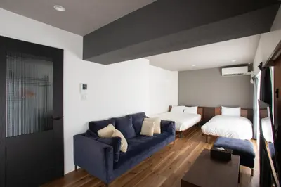 a living room with a couch and a bed at NIYS apartments 56type in Tokyo