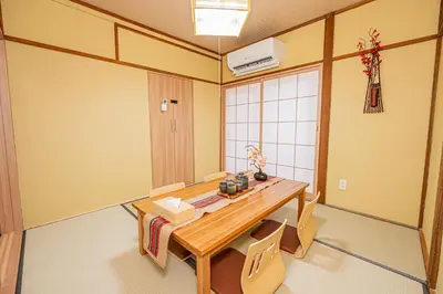 a dining room with a wooden table and chairs at skytree Family Hotel in Tokyo