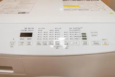 a white washing machine with stickers on the top of it at skytree Family Hotel in Tokyo