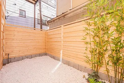 a wooden retaining wall next to a building at skytree Family Hotel in Tokyo