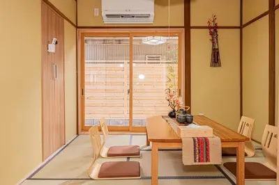 a dining room with a table and chairs and a window at skytree Family Hotel in Tokyo