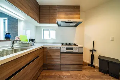 a kitchen with wooden cabinets and a sink at Kokoon Hotel Yotugi in Tokyo