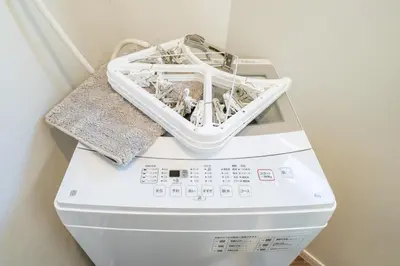 a washing machine with a basket on top of it at Kokoon Hotel Yotugi in Tokyo