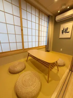 a room with a table and two stools at M house asakusa kaminarimon tokyo in Tokyo