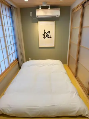 a large white bed in a room with windows at M house asakusa kaminarimon tokyo in Tokyo