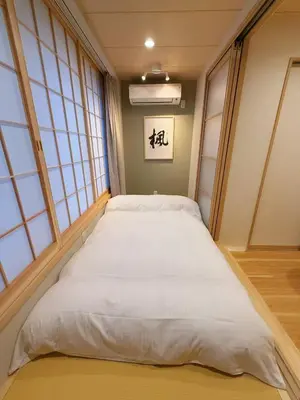 a large bed in a room with windows at M house asakusa kaminarimon tokyo in Tokyo