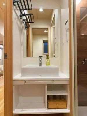 a bathroom with a sink and a mirror at M house asakusa kaminarimon tokyo in Tokyo