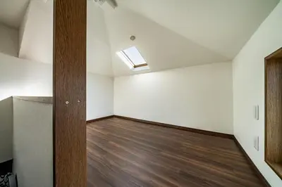 an empty room with a skylight and wood floors at Kokoon Hotel Shibamata in Tokyo