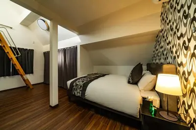 a hotel room with a bed and a lamp at Kokoon Hotel Shibamata in Tokyo
