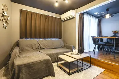 a living room with a couch and a table at Sumu Hotel Shinjuku in Tokyo